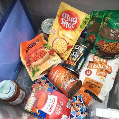 box containing tins and packets of food