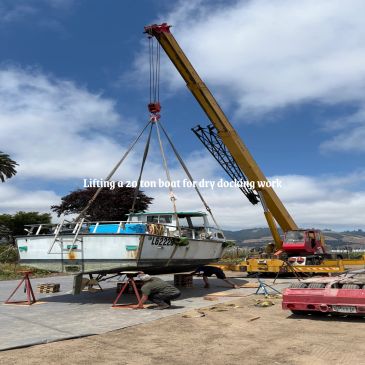 Crane lifting a 20-ton boat for maintenance.