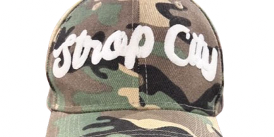 Camouflage cap with the words 'Strap City' embroidered in white.