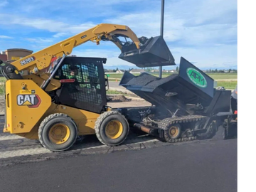 APM with our CAT Skid steer and Paver Paving a Parking Lot at Days Inn Hotel Grande Prairie Alberta
