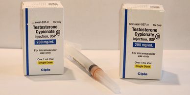 Testosterone prescription boxes and syringe