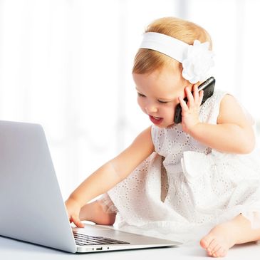 Baby with laptop and mobile phone