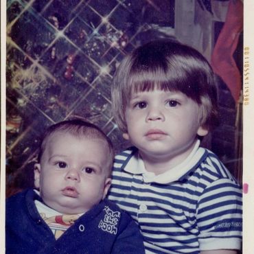 Baby and toddler in striped shirts.