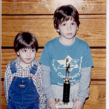 Two boys standing with a trophy.