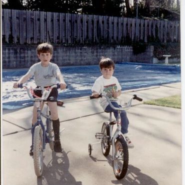 Two boys posing in athletic gear.