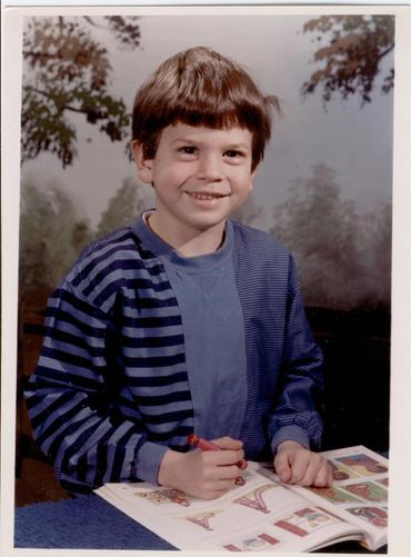 Young boy coloring in a book.