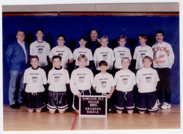 Youth basketball team group photo in a gym.