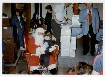 Child sitting on Santa Claus's lap.