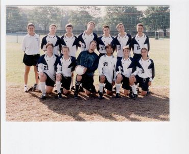 Youth soccer team group portrait outdoors.