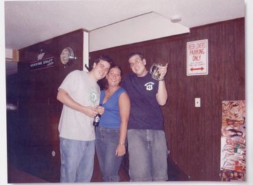 Two men standing by collage table.
