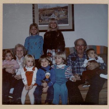 Large family group sitting on a sofa.