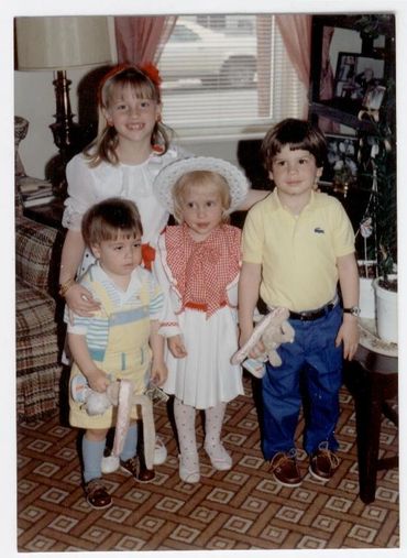 Four children posing for a formal photo.