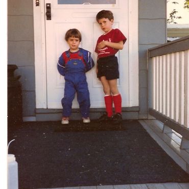 Children on a porch with a "Sold" sign.
