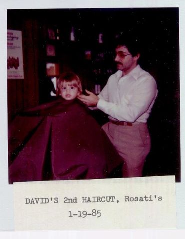 Young child getting haircut in 1985.