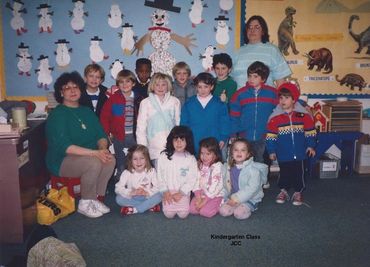 Group of children posing in classroom.