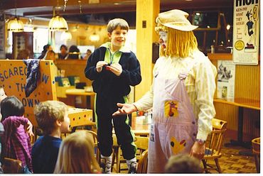 Kid talking to a costumed clown.