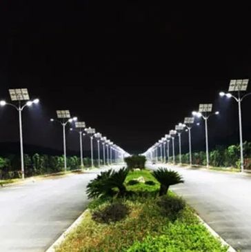 Solar-powered streetlights illuminating a deserted road at night.