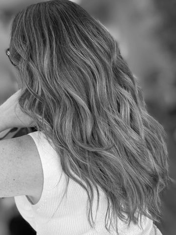 Long wavy hair cascading down the back in black and white.