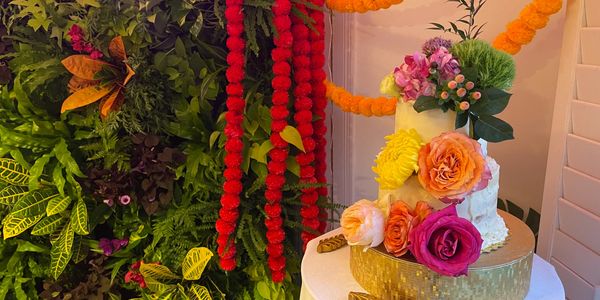 Red Velvet Wedding Cake with themed matching flowers and flower wall. Custom to your theme!