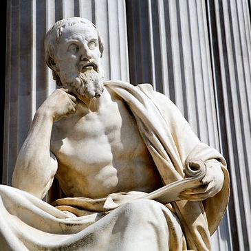 Marble statue of a thoughtful ancient philosopher holding a scroll.