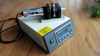 A laboratory device with a digital display and motorized component on a wooden floor.