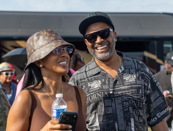 Smiling couple enjoying an outdoor event.