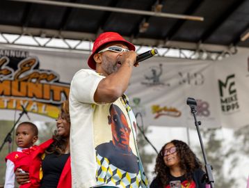 Man singing on stage with microphone.