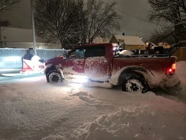 Truck with snow plow in snow