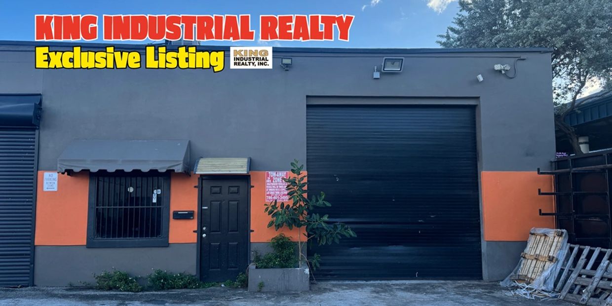 Commercial industrial building with a large garage door and entrance, listed by King Industrial Realty.