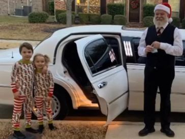 two kids going on a christmas light tour with a driver dressed as santa in a limo 