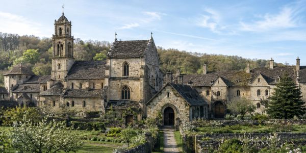 Historic stone church and buildings in a rural setting.