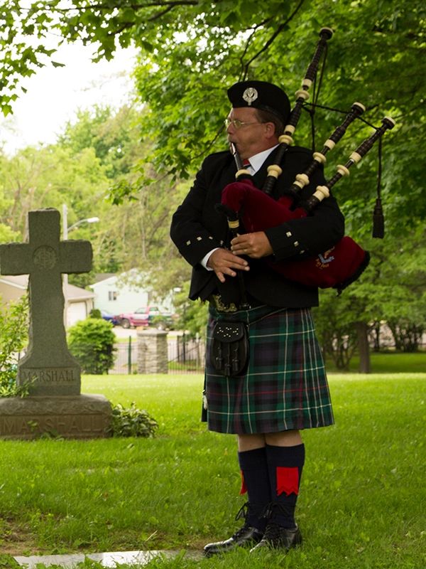 Bagpiper at a funeral.