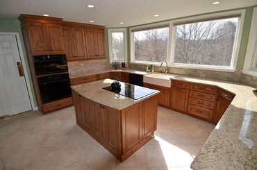 Granite counters and island in a large kitchen.