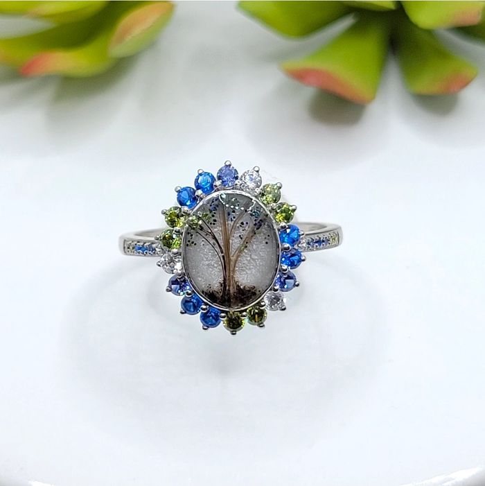 A diamond ring with blue green stones