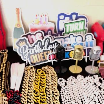 Colorful birthday party props and jewelry on display.