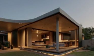 Modern open-concept house with large glass windows.