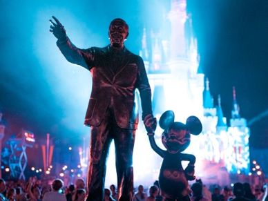 Statue of Walt Disney and Mickey Mouse in front of Cinderella's Castle at Disney World, Orlando, FL