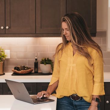 image of realtor working on laptop in kitchen