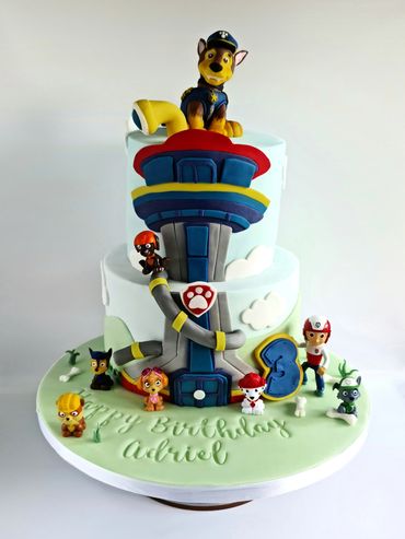 Two-tier Paw Patrol Cake with Chase model on the top.