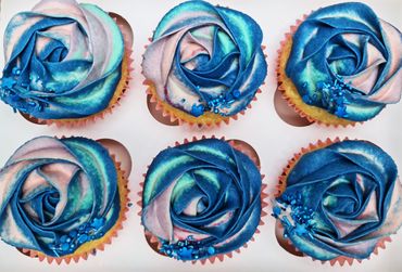 Vanilla cupcakes with pretty blue and pink swirls of salted caramel buttercream
