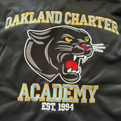 A black color hoodie with Oakland charter academy logo 