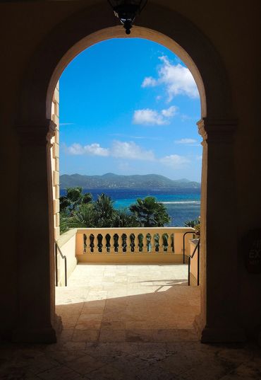 view of ocean and blue sky through keyhole doorway BVI