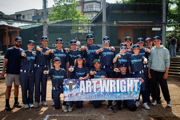 Youth baseball team posing with a banner at Art Wright Memorial Day Classic.