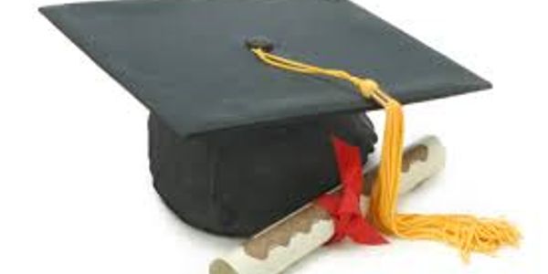 Graduation cap with diplomas tied with ribbons.