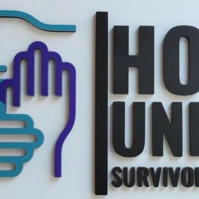Sign with hand graphic and text 'HOPE UNIT SURVIVOR'.