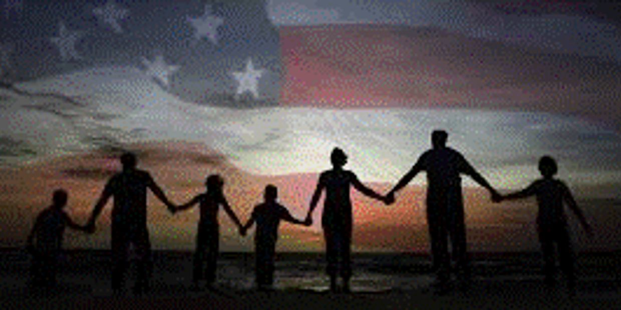 Silhouettes of people holding hands with an American flag in the background.