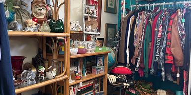 A cozy room filled with vintage decor and a colorful clothing rack.