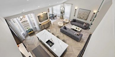 Modern open-concept living area with stylish furniture and a kitchen island.