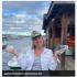 Woman in captain's hat by the water