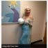 Woman in light blue dress holding a globe